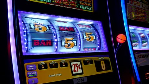 Coquitlam, BC, Canada - November 10, 2015 : Close up woman playing slot machine inside Hard Rock Casino with 4k resolution
