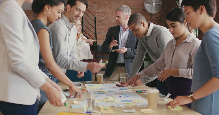 Multi-ethnic business team meeting brainstorming sharing new ideas Diverse team involved in teamwork in trendy brick office space steadicam shot across boardroom table shared work space Royalty-Free Stock Footage #12720515