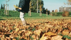 Cute little girl playing outside with autumn leaves. Shoot on Digital Cinema Camera in 4k slow motion - ProRes 422 codec.