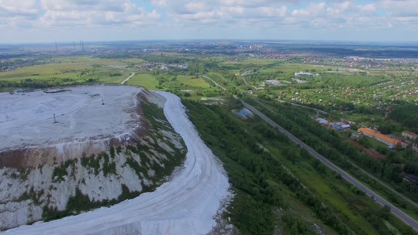 White Mountain near road with traffic at summer day. Aerial view