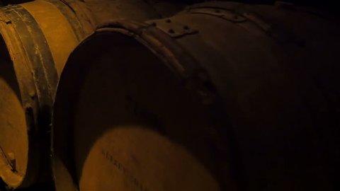 The dusty wine barrels on the storage room inside the wine cellar