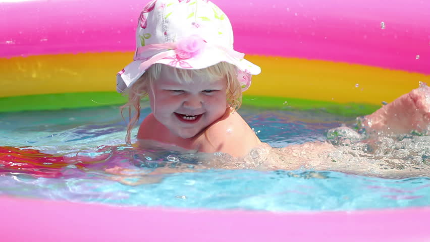 baby-girl bathes in a pool