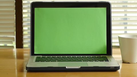 Dolly shot - Laptop computer notebook with green screen monitor