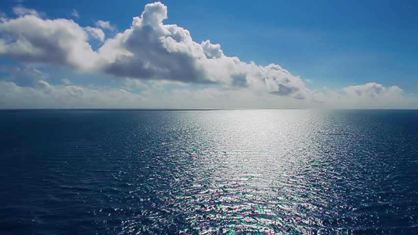 The sun glistens on the ocean on a warm summer day.  Shot at 60fps for true slow