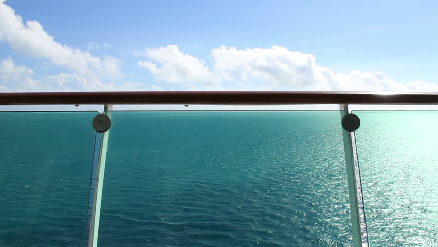 Looking over the banister at the ocean on a cruise liner.
