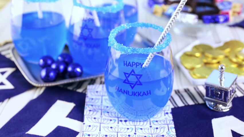 Table set with cocktails and chocolates to celebrate Hanukkah.