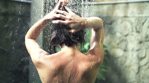 Young woman washing hair under shower, super slow motion, shot at 240fps
