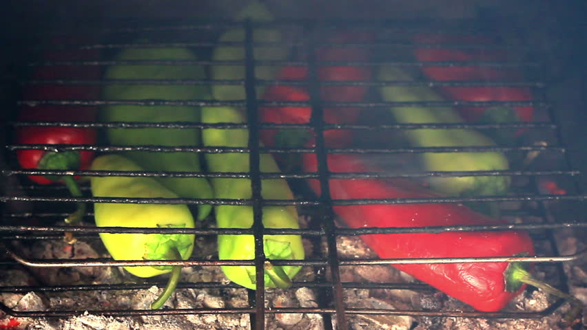Red and green peppers grilled on the fire 