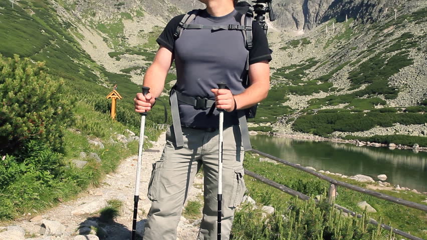 Portrait of young handsome hiker in the mountains, camera stabilizer shot 