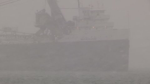 Ontario, Canada January 2015 Ship / freighter taking shelter in bay from severe wind waves and blizzard