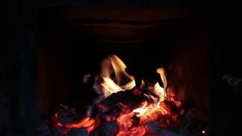 Fireplace with roaring wood fire, inside of oven with embers and is great for dark background