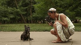 Woman with old camera filming a dog