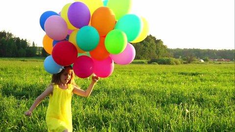 Little girls with balloons outdoors