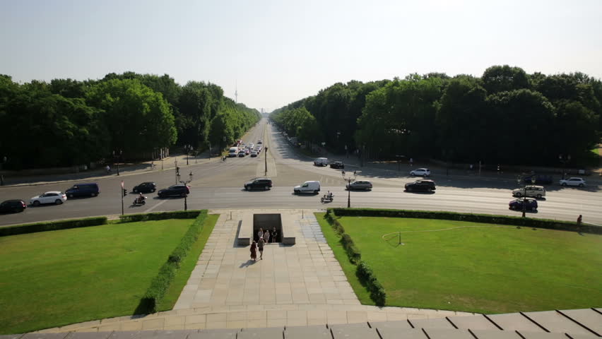 Berlin cityscape view from Victory monument along Hofjageralle wide angle view with red train crossing bridge, tiergarten, and cityscape - closer view