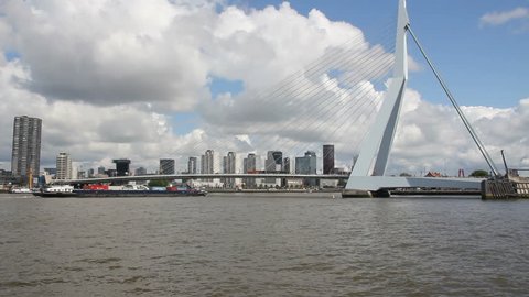 Ship with containers passes under the Erasmus bridge in Rotterdam, Holland