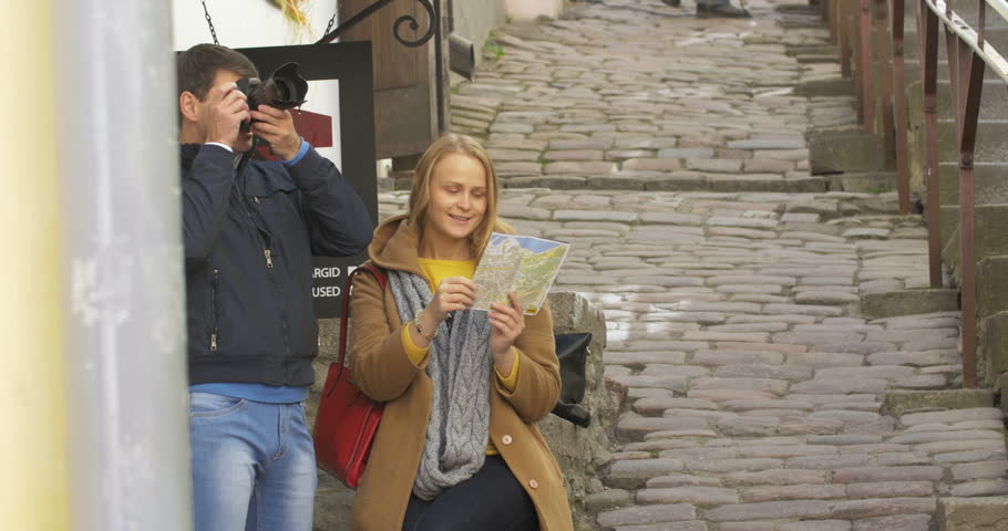 Couple of tourist with camera and map