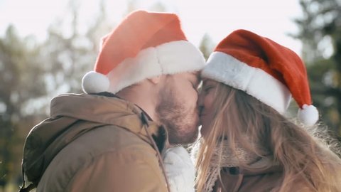 Romantic couple hugging and kissing in winter park