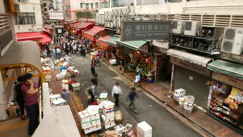 HONG KONG - MARCH 31, 2015: Intercity marketplace, Bowrington Road Market from above, Time lapse shot. Wan Chai district, unidentified citizens walk along alley.