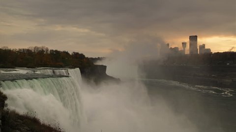 A panoramic sunset to dusk and nighttime time-lapse of Niagara falls on the USA side including the light show. A close up of the American Falls and a far away view of Ontario's landmark buildings.