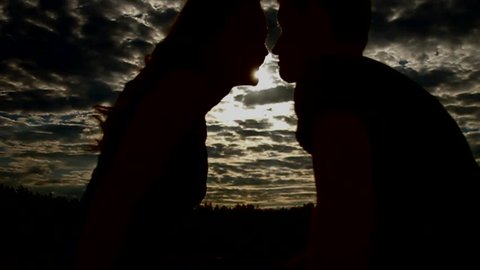 The lovers silhouette close up portrait view by  background. The kiss action in this video