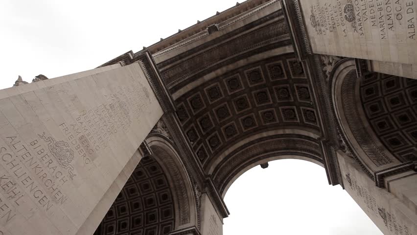 Arc De Triomphe on a cloudy day. Slow pan under the Arc. Left to right.
