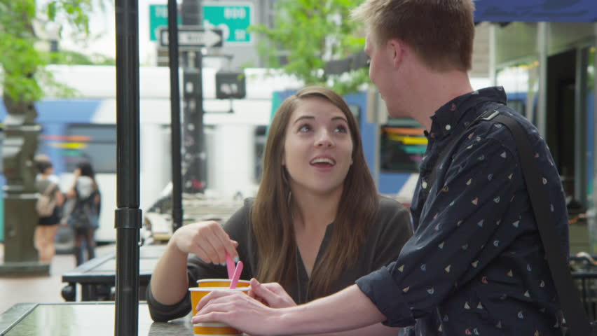 Young couple eating yogurt