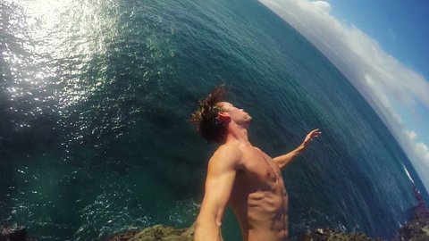 POV Slow Motion GOPRO Selfie Stick Cliff Jumping Backflip. Athletic Young Man Jumping From Cliff Into Ocean. Adventure Extreme Sports Lifestyle Hobby Vacation