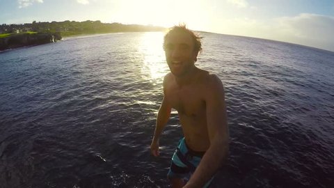 POV Slow Motion GOPRO Selfie Stick Cliff Jumping. Athletic Young Man Jumping From Cliff Into Ocean. Adventure Extreme Sports Lifestyle Hobby Vacation