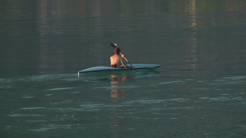 Athletic man kayaking in a lake