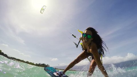 Young Woman Kitesurfing in Ocean in Bikini. Extreme Summer Sports POV GOPRO Slow Motion.