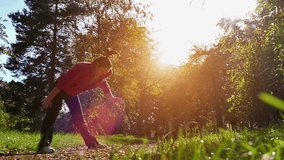 A young woman doing exercise in nature, Slow Motion of Exercise in a Nature, Slow Motion Video Clip