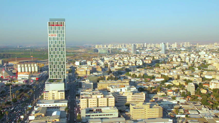 Aerial view of cityscape of Ramat Gan, Bnei Brak and Petah Tikva. Pan left. Places like Ramat Gan Stadium, Hayarkon Park, Ayalon Mall, Ramat Hahayal neighborhood of Tel Aviv.