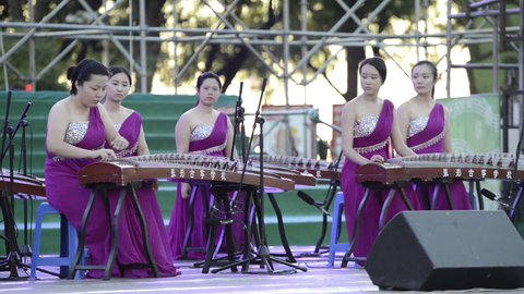 Harbin, China -  August 9, 2015: A group of girls are playing guzheng. Located in Central Avenue (Zhongyang Street). Harbin City, Heilongjiang Province, China.