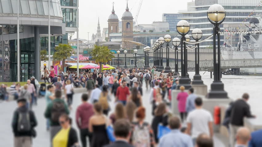 London, England - June 17, 2015: Crowds walking along London Riverside next to City Hall, River Thames, London ,Britain