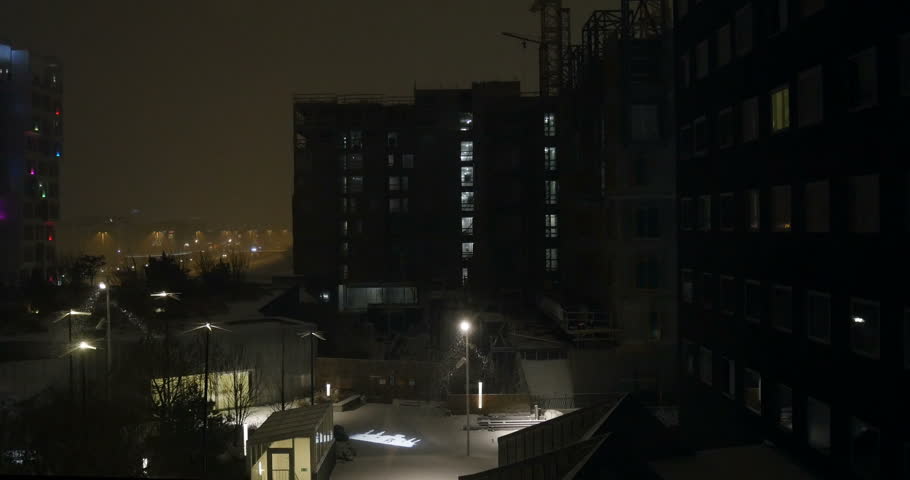View of snow falling over Copenhagen with high skyscraper buildings in the background and Copenhagen streets in the perspective