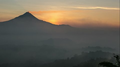 4k Time Lapse of sunrise over Merapi mountain and Borobudur temple