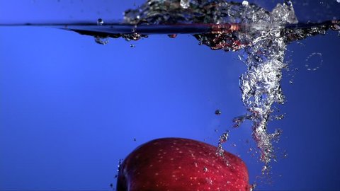Apple splashes into water slow motion