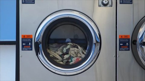 public laundromat washer with clothes inside