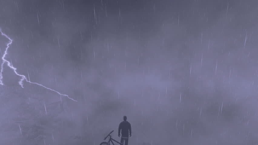 Cyclist on top of the mountain, storm with lightning