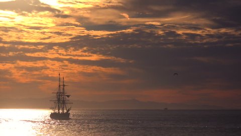 CALIFORNIA - CIRCA 2015 - A tall clipper ship sails at sunset.