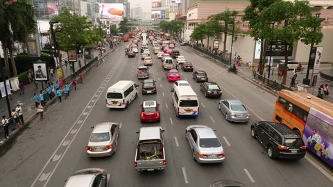 BANGKOK - MARCH 24, 2015: Traffic congestion in middle lanes, long slide shot over the carriageway, wide angle perspective view of the Ratchadamri road, Pathum Wan district
