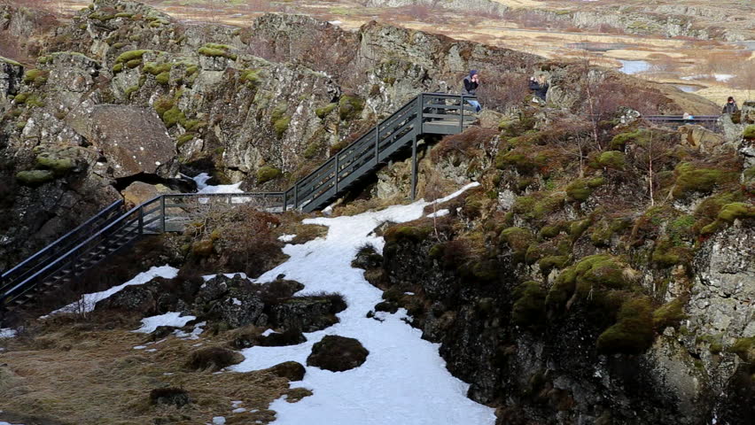 tourists looking at the Reykjanes Ridge also know as the Atlantic Mid Ocean Ridge Iceland