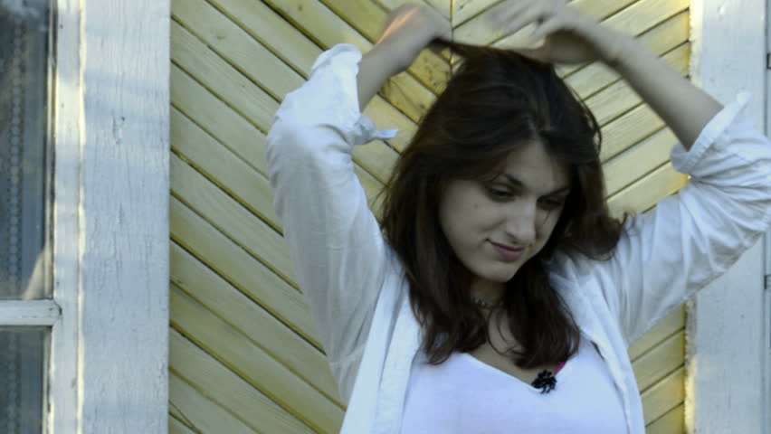 Young woman combs hair