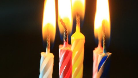Birthday candles macro clip. Candles in flames, slowly burning down.