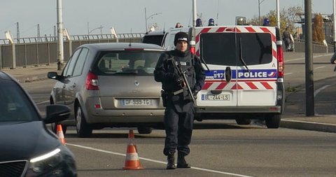 STRASBOURG, FRANCE - NOV 14 2015: French Police with machine gun checking vehicles on the 'Bridge of Europe' between Strasbourg and Kehl Germany, as a security measure in the wake of attacks in Paris