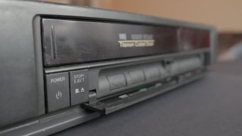 Inserting a VHS Tape into a VCR Player. Sound included. Flat Picture Profile