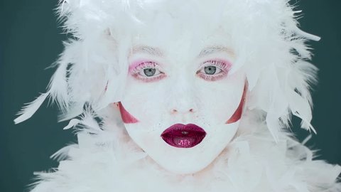  portrait of a woman mime or a clown and bodypainting white with red lips and red eyes