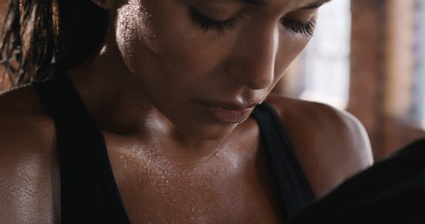 Beautiful Kickboxing gym woman training punching bag in fitness studio fierce strength fit body breathing slow motion