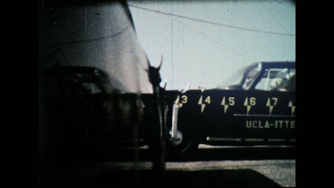 UNITED STATES 1960s – Test cars crash. Crash test dummies in car during impact.