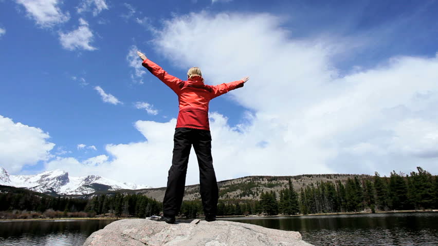 Female celebrating achieving her ambition to hike through the Rockies National Park